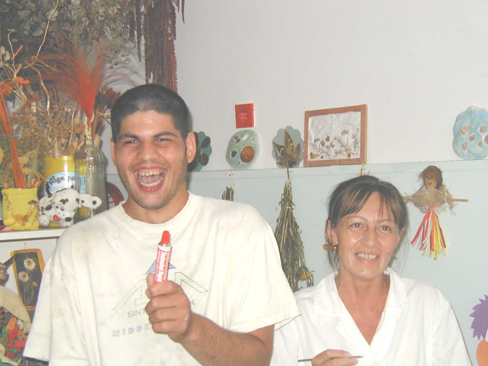 A student from the art therapy class with his teacher.